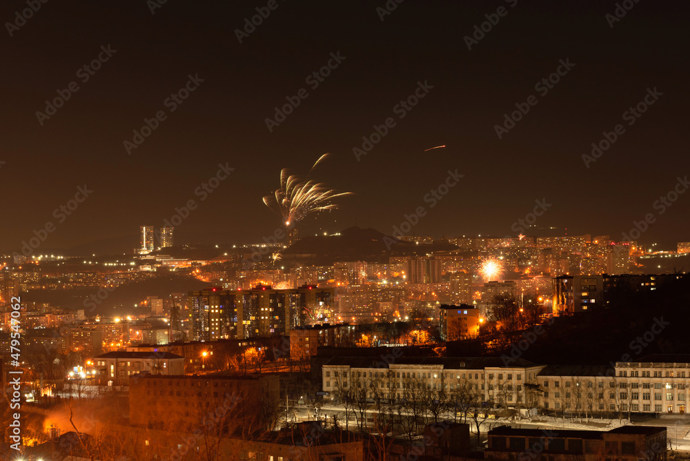 Fireworks in the city at night during New Year celebration. Soft focus background