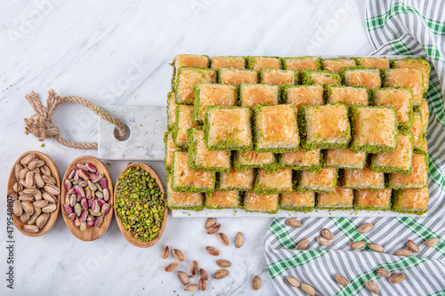 Turkish sweet Dry Baklava on a marble background. Turkish pastry dessert baklava. Ramadan or holiday desserts concept. Antep Baklavasi. local name; Kuru Baklava. photo