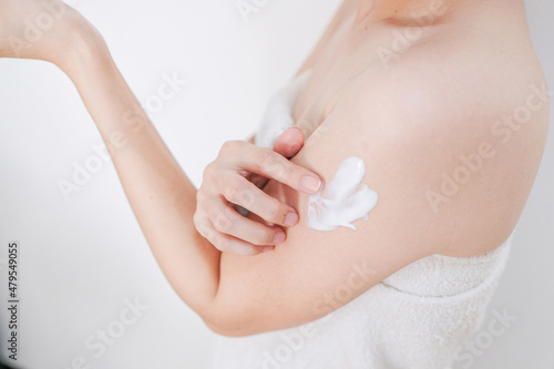 Woman applying cream,lotion on arm with white background, Beauty concept.