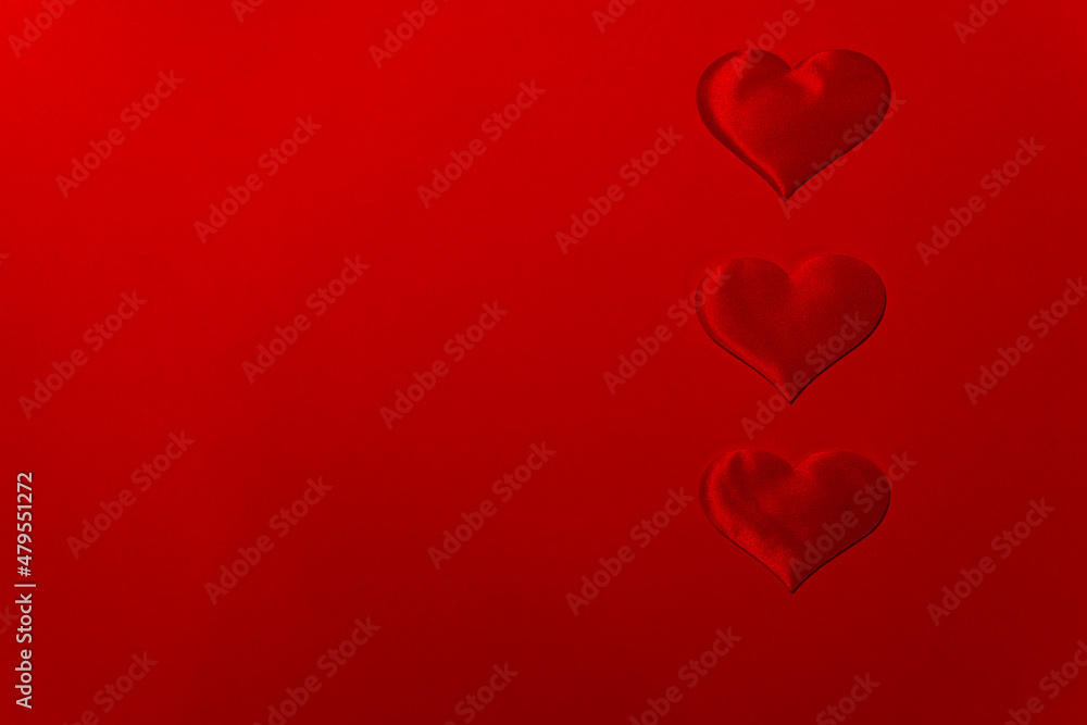 Three hearts on a red background with copy space for valentine's day.