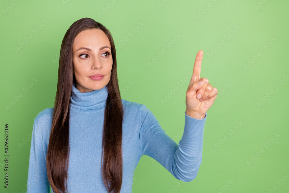 Photo of confident lady touch empty space virtual reality interface wear blue turtleneck isolated green color background Photo of confident lady touch empty space virtual reality interface wear blue turtleneck isolated green color background