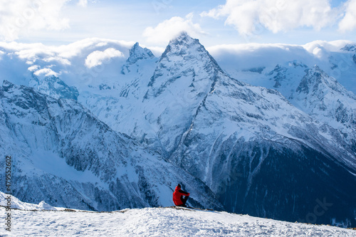 A man sitting at the edge of a rock