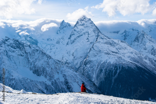 A man sitting at the edge of a rock