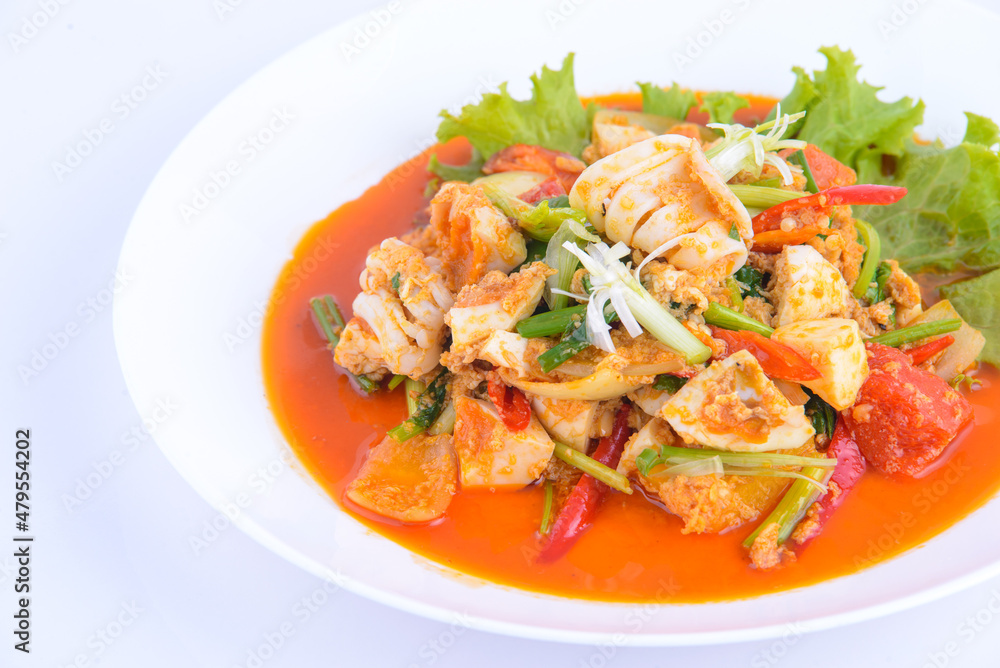 Sweet and sour squid stir fried on the white dish. Sweet and sour squid stir fried on the white dish.
