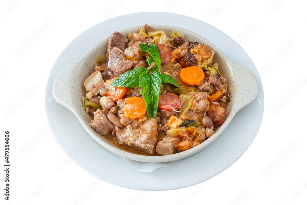Delicious traditional Portuguese dish feijoada and sewn with smoked sausage with carrots with cabbage and mint leaves. On isolated white background.