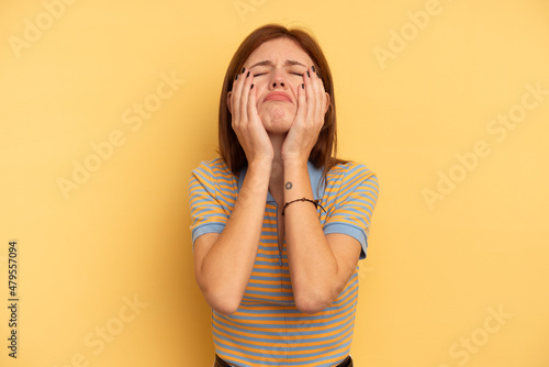 Young English woman isolated on yellow background whining and crying disconsolately.