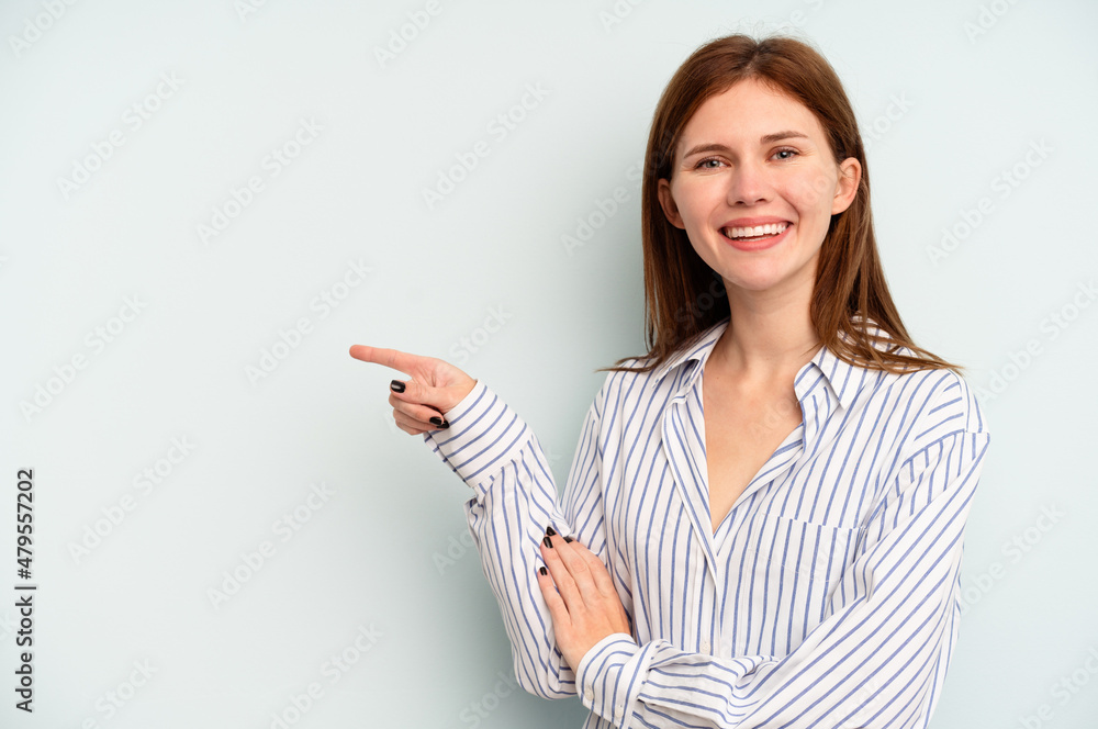 Young English woman isolated on blue background smiling cheerfully pointing with forefinger away. Young English woman isolated on blue background smiling cheerfully pointing with forefinger away.