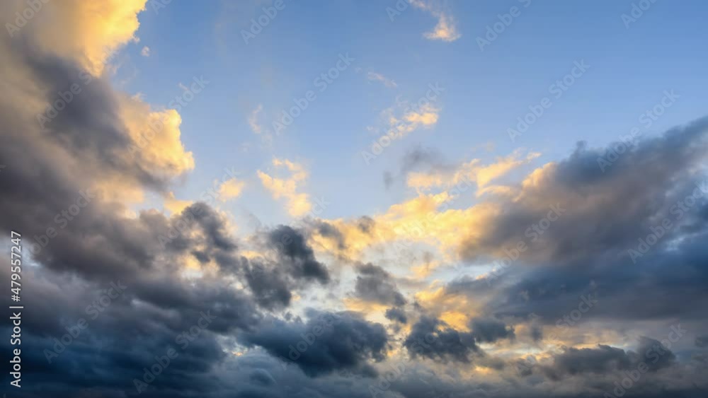 4k time lapse. Rolling dark clouds in the blue sky. Yellow clouds and black clouds landscapes at sunset. 4k time lapse. Rolling dark clouds in the blue sky. Yellow clouds and black clouds landscapes at sunset.