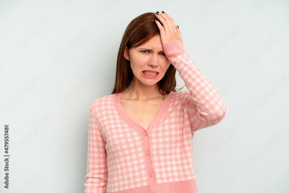 Young English woman isolated on blue background forgetting something, slapping forehead with palm and closing eyes. Young English woman isolated on blue background forgetting something, slapping forehead with palm and closing eyes.