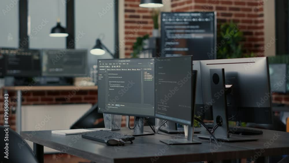 Computer monitors displaying parsing code in empty it agency office and computers compiling data algorithms in background. Artificial intelligence servers cloud computing in data room. Computer monitors displaying parsing code in empty it agency office and computers compiling data algorithms in background. Artificial intelligence servers cloud computing in data room.