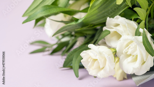 White roses bouquet on color background. Text space