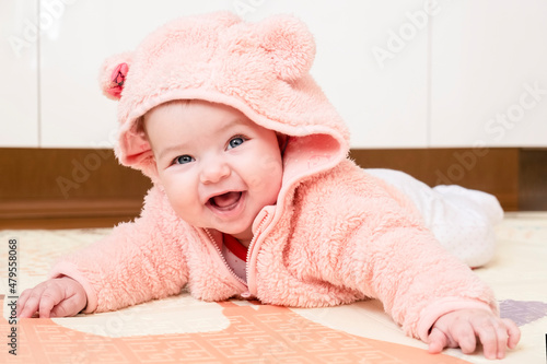 Infant baby liying on his stomach and smiling photo