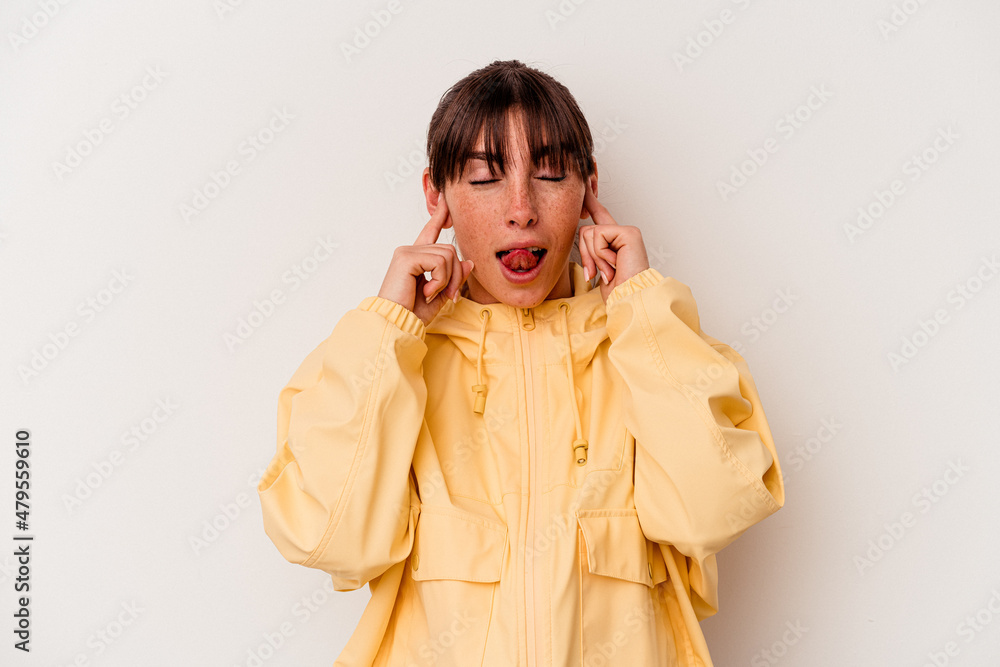 Young Argentinian woman isolated on white background covering ears with fingers, stressed and desperate by a loudly ambient. Young Argentinian woman isolated on white background covering ears with fingers, stressed and desperate by a loudly ambient.