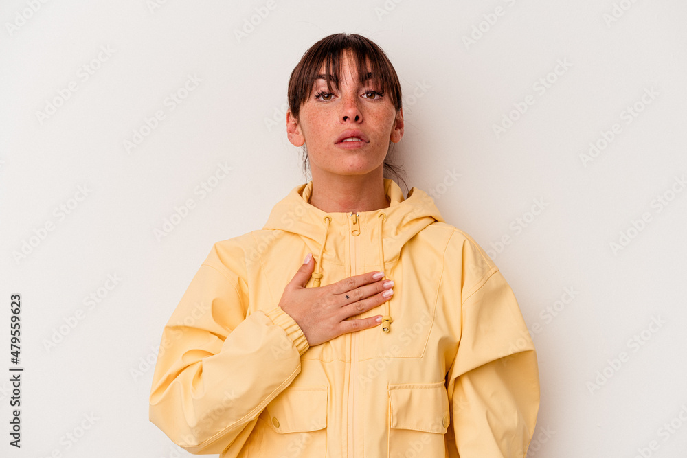 Young Argentinian woman isolated on white background taking an oath, putting hand on chest. Young Argentinian woman isolated on white background taking an oath, putting hand on chest.