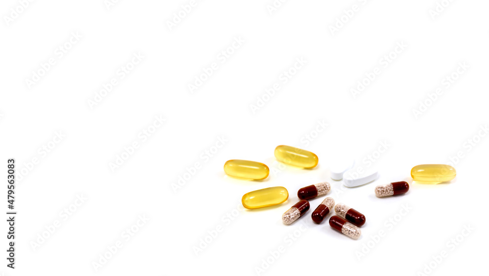 Composition with pills on the table. Heap of open medicines on a white paper background. Composition with pills on the table. Heap of open medicines on a white paper background.