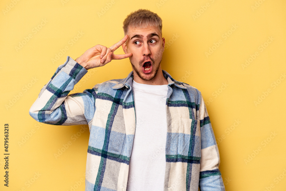 Young caucasian man isolated on yellow background dancing and having fun. Young caucasian man isolated on yellow background dancing and having fun.