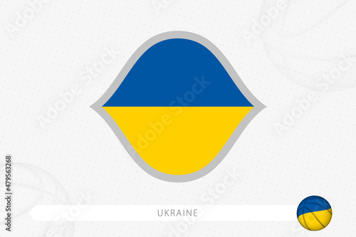 Ukraine flag for basketball competition on gray basketball background.