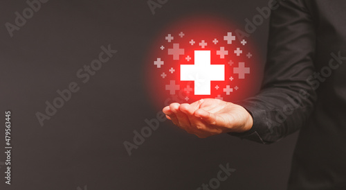 Health care and business health insurance concept. Virtual medical icons on the palm businessman against a gray background