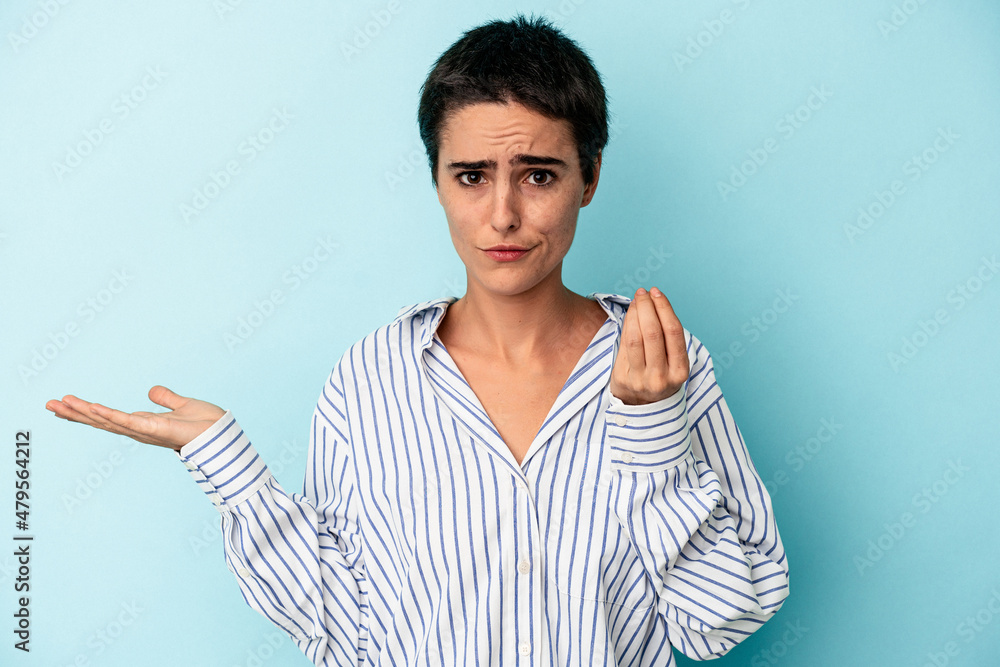 Young caucasian woman isolated on blue background showing that she has no money. Young caucasian woman isolated on blue background showing that she has no money.