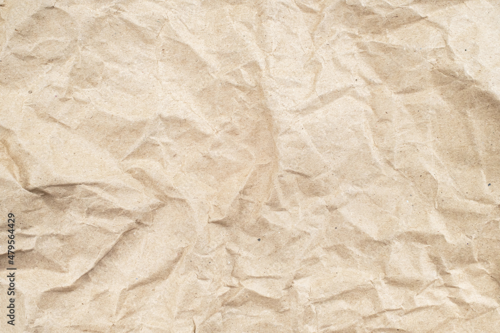 Fototapeta premium Recycled brown creased paper background from a paper packing. Crumpled brown paper texture concept