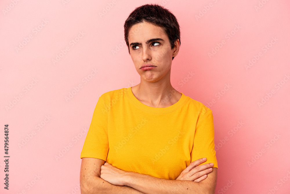 Obraz premium Young caucasian woman isolated on blue background tired of a repetitive task.