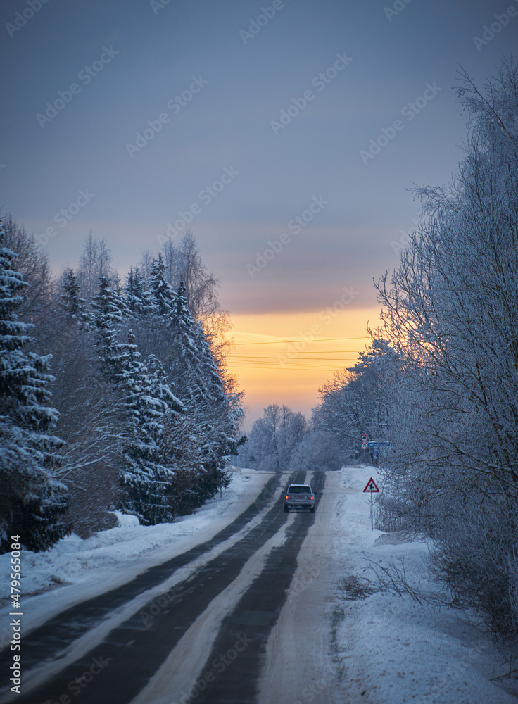 Fototapeta premium sunrise with clouds cold winter morning with snowy asphalt road