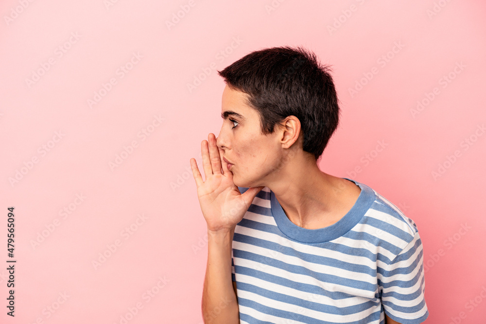 Young caucasian woman isolated on blue background is saying a secret hot braking news and looking aside Young caucasian woman isolated on blue background is saying a secret hot braking news and looking aside
