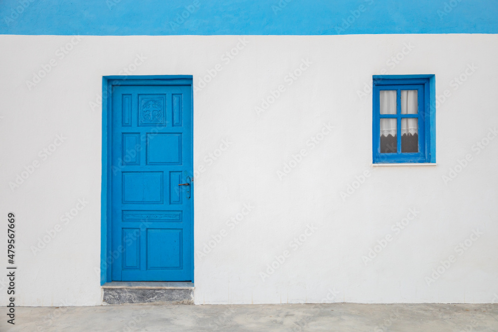 Traditional facade of a greek house with blue door