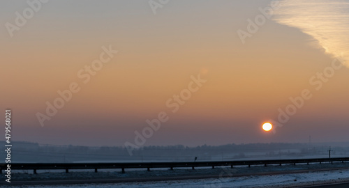 Winter landscape in snow nature with sun  field and trees. Magical winter sunset in a snow field.