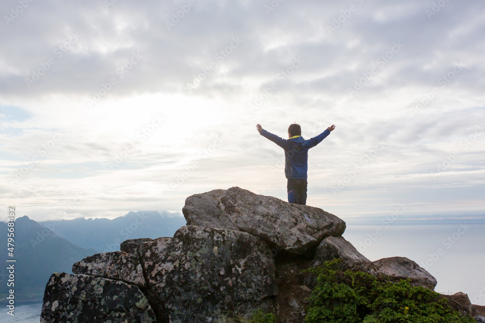 Happy family, standing on a rock and looking over Segla mountain on Senja island, North Norway. Amazing beautiful landscape and splendid nature Happy family, standing on a rock and looking over Segla mountain on Senja island, North Norway. Amazing beautiful landscape and splendid nature