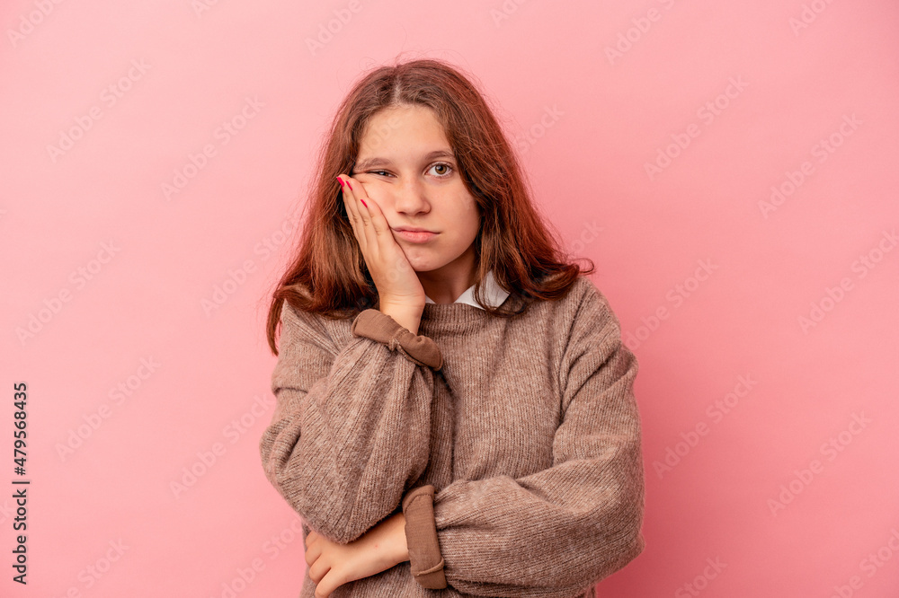 Little caucasian girl isolated on pink background who is bored, fatigued and need a relax day. Little caucasian girl isolated on pink background who is bored, fatigued and need a relax day.