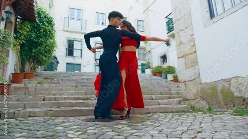 Beautiful Couple Dancing a Latin Dance on the Quiet Street of an Old Town in a City. Sensual Dance by Two Professional Dancers on a Sunny Day Outside in Ancient Culturally Rich Tourist Location.