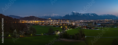 Panorama view of the famous city of Salzburg in the evening at the blue hour, in the background the snow-covered Berchtesgaden Alps, Austria, Europe
