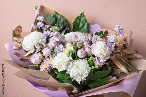 Fototapeta Naklejka Na Ścianę i Meble -  Beautiful bouquet with chrysanthemums, roses, carnations on color background. Decorative floral composition. copy space