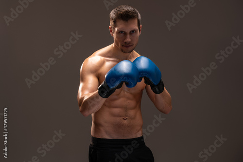 Waist up portrait view of the sportsman boxer fighting in gloves in boxing cage isolated on brown background. Stock photo © NFstock