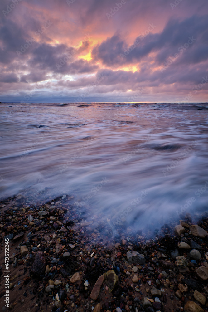 long exposaure sunset stones beach clouds windy