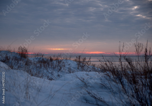 sunset with clouds at a snowy beach