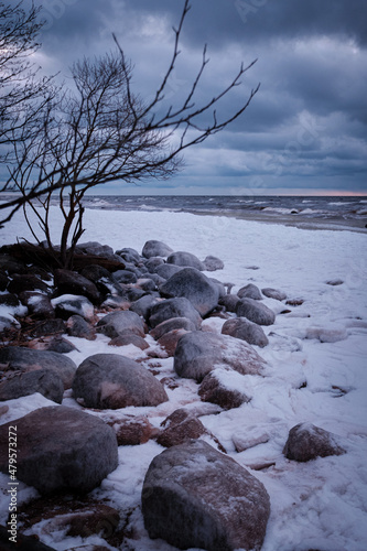 rocks at the beach snowy winter sea coast clouds