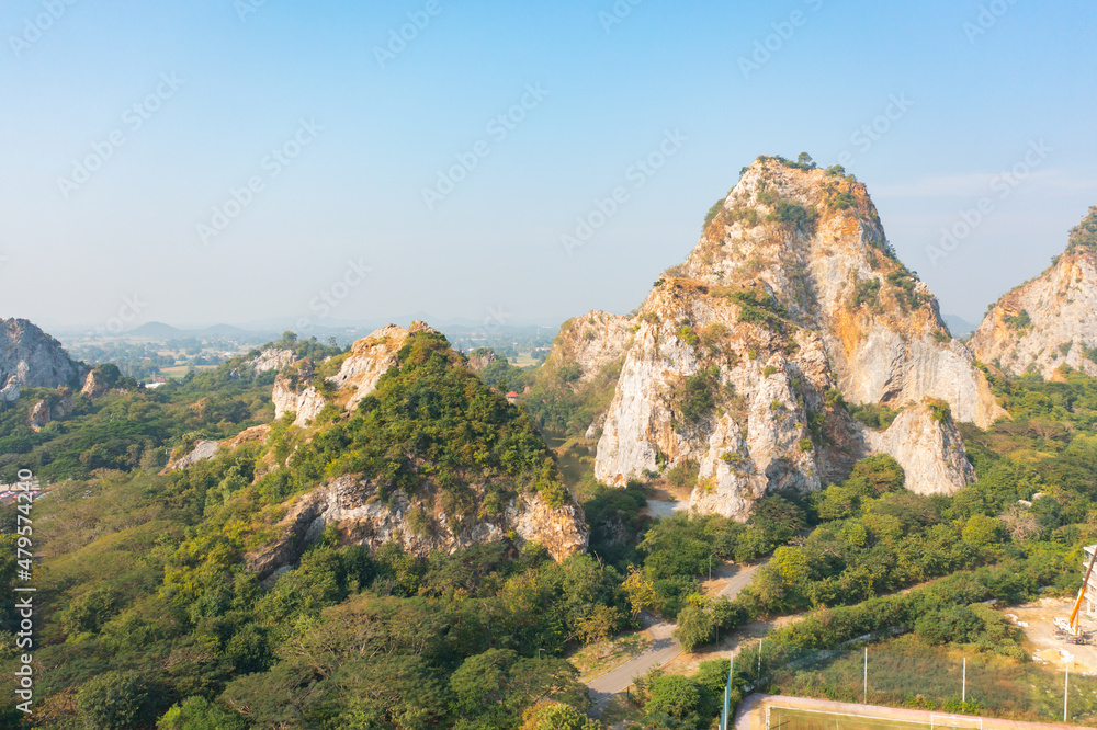 Aerial view of Khao Ngu Stone. National park with river lake, mountain valley hills, and tropical green forest trees at sunset in Ratchaburi, Thailand in travel trip. Natural landscape background.