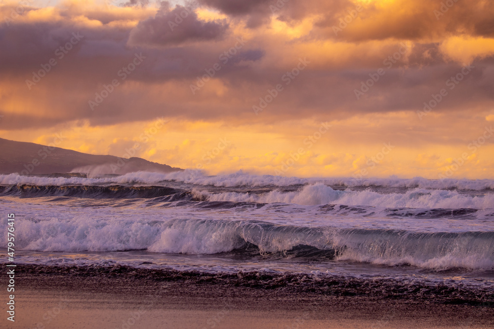 Azores islands, beach with amazing waves and colors, sunset.