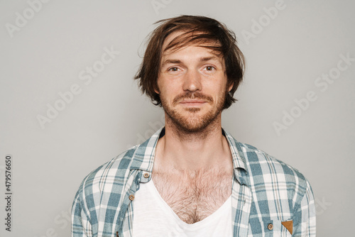 White unshaven man in shirt smiling and looking at camera