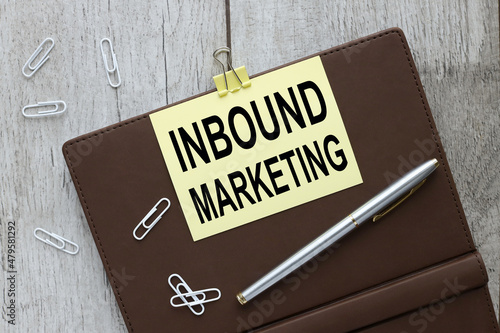 Inbound marketing inscription on a closed brown notebook on a sticky yellow sticker