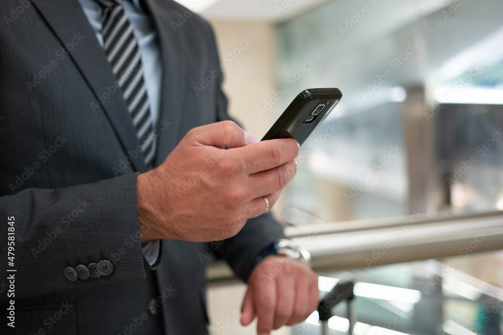 Commuter looking at his mobile phone Commuter looking at his mobile phone