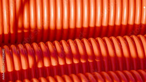 Red corrugated plastic tubes. Industrial background. Products from plastic. Drainage and sewerage. Urban network.