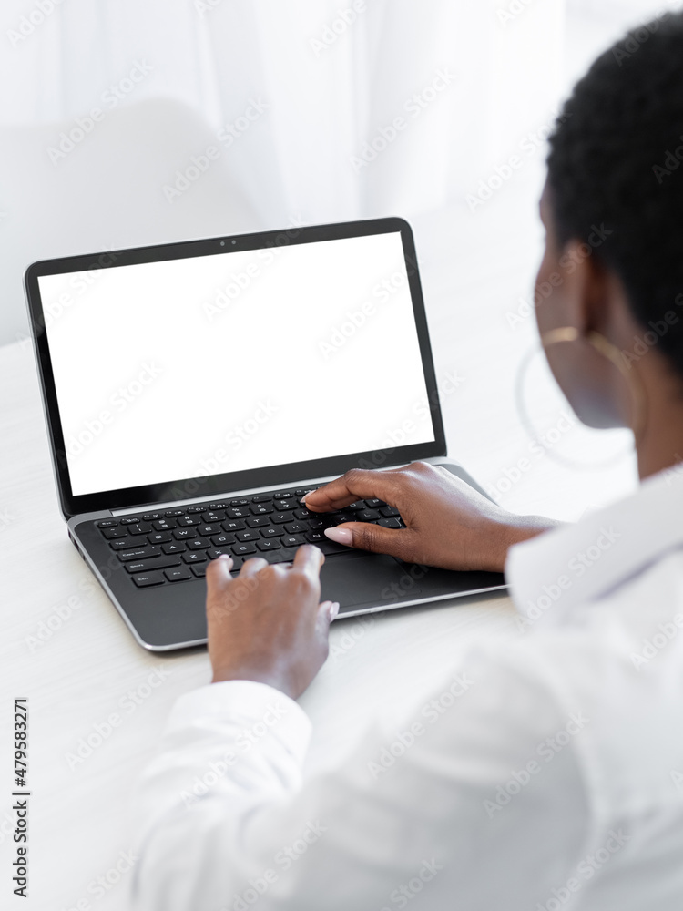 Laptop working. Remote job. Freelance lifestyle. Wireless device. Unrecognizable business woman typing at blank mockup screen notebook at office desk workplace. Laptop working. Remote job. Freelance lifestyle. Wireless device. Unrecognizable business woman typing at blank mockup screen notebook at office desk workplace.