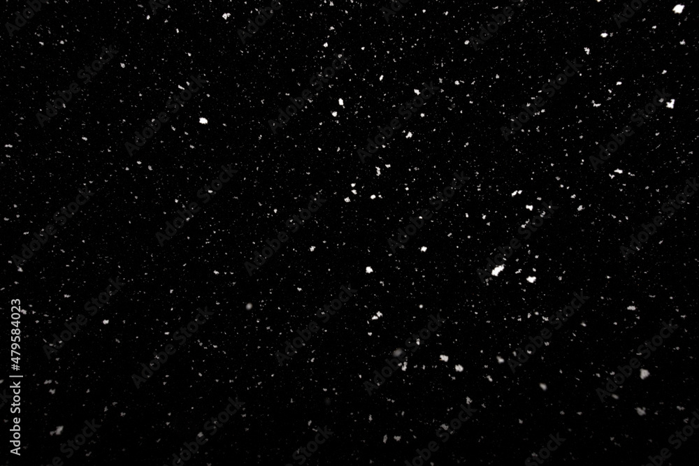 Falling snow freeze motion in the dark sky. Texture isolated on black background. Perfect for white snowflakes overlay, winter abstract