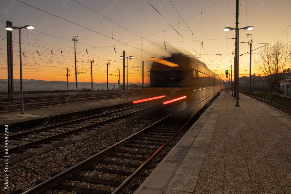 Train starting the journey at Mangualde station in Viseu district during sunset