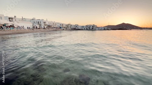 beautiful sunset on the clear sea, promenade with restaurants, Greek cycladic island Paros Naoussa Greece