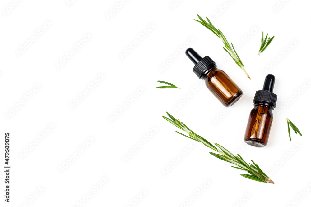 Natural rosemary essential oil or extract with fresh rosemary branches on white isolated background. Organic cosmetics flat lay image with copy space. Natural rosemary essential oil or extract with fresh rosemary branches on white isolated background. Organic cosmetics flat lay image with copy space.