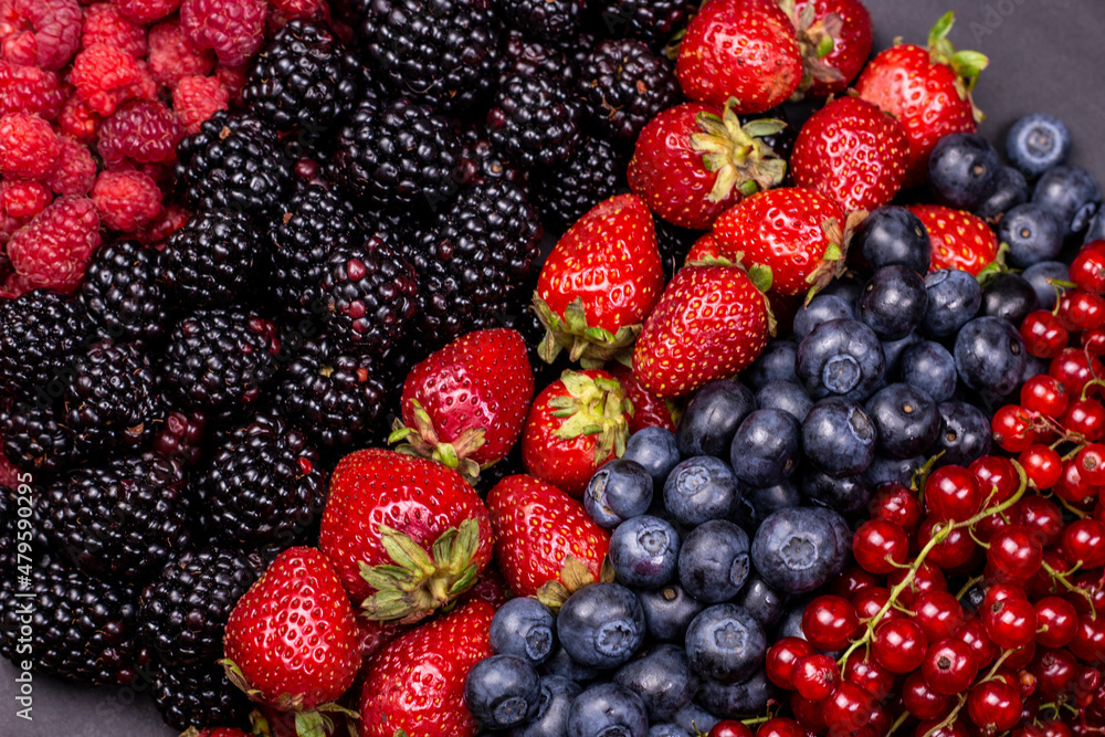 Different berry fruits background. Strawberry, blueberry, raspberry, red currant and blackberry mix. Different berry fruits background. Strawberry, blueberry, raspberry, red currant and blackberry mix.